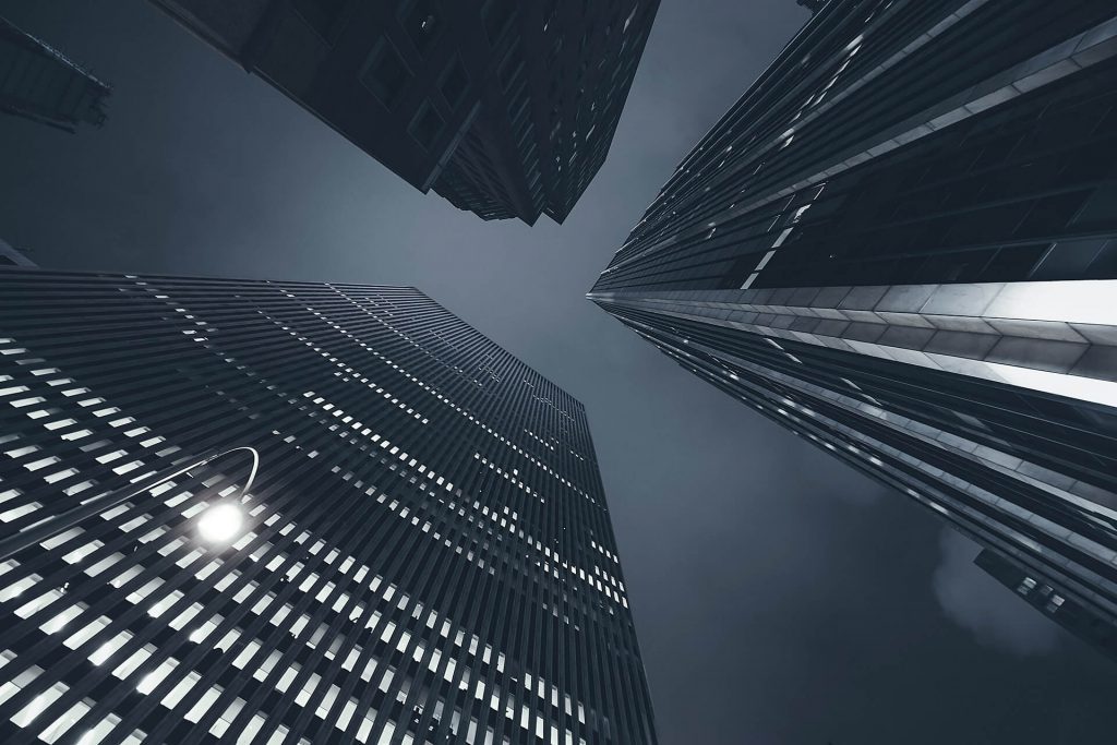 A view from the ground looking up at NYC skyscrapers